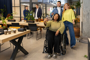 Diverse business team taking selfie in modern coworking space
