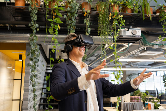 Businessman exploring virtual reality in modern green office