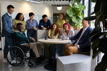 Diverse business team enjoying coffee break in modern coworking space
