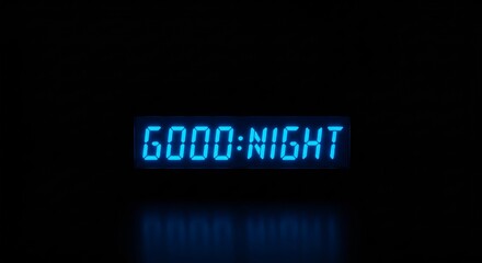Blue glowing digital sign displaying good night message on black background. Sleeping and evening concept. Led clock display