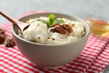 Taking delicious rice pudding at table, closeup