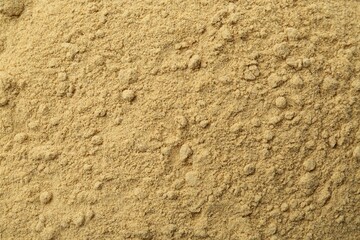 Superfood. Mustard seeds powder as background, closeup