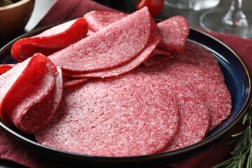Slices of delicious sausage served on table, closeup