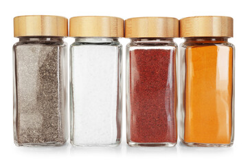 Many different aromatic spices in jars isolated on white