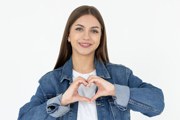 Positive healthy happy young woman show heart sign smiling, cherish relationship, express love care and delight, confess feelings for family, sympathy, stand white background