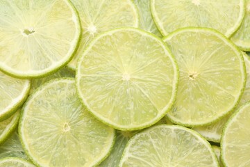 Slices of fresh limes as background, top view