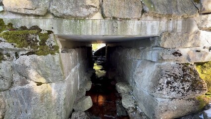 Explore the Ancient Stone Structure with a flowing water creek in a beautiful landscape