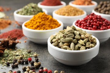 Different aromatic spices on grey table, closeup
