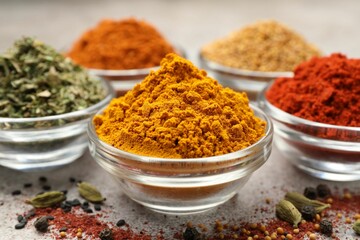 Different aromatic spices on light grey table, closeup