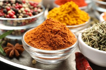 Different aromatic spices in bowls on table, closeup
