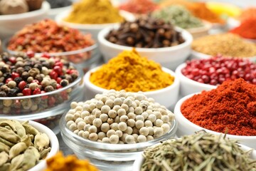 Different aromatic spices in bowls on table, closeup