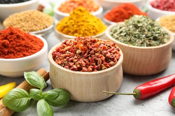 Different aromatic spices on grey table, closeup