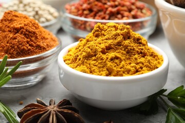 Different aromatic spices in bowls on table, closeup