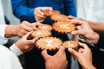 Team Collaboration and Strategy Development with Wooden Gear Symbols Representing Business Goals and Achievements in a Professional Environment. Amity