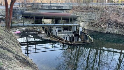 A Tranquil Waterway Scene Featuring an Industrial Structure, with Beautiful Reflections