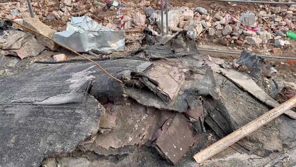 Deteriorated concrete and debris at the site indicate extensive damage needing urgent cleanup