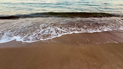 Experience the peaceful serenity of stunning beach waves under a beautiful sunset