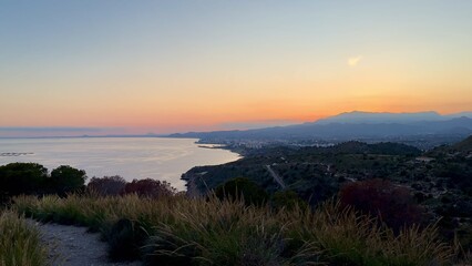 A Beautiful and Serene Sunset Over a Scenic Coastal Landscape with Vibrant Colors