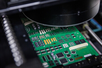 Russia. Moscow. Conducting non-destructive testing on an electronic circuit board.