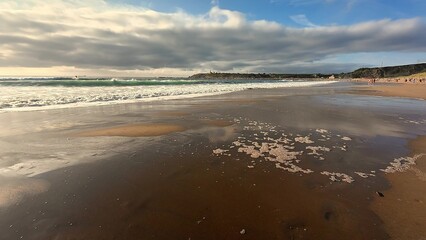 Experience the Serene and Calm Beach Waves with Stunning Dramatic Reflections of Clouds