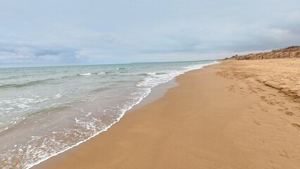 A Serene Beach Featuring Gentle Waves Lapping Against the Soft, White Sand Shoreline