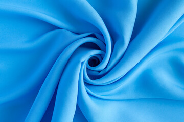 Obraz premium Close-up of vibrant blue fabric with creative folds and unique textures