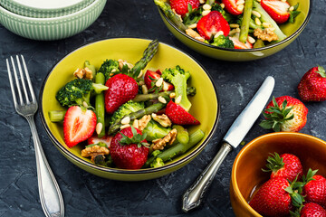 Vegan salad of green asparagus, strawberries.