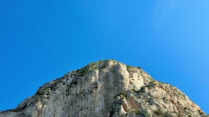 The Majestic Mountain Peak Stands Tall Under a Clear and Radiant Blue Sky High Above