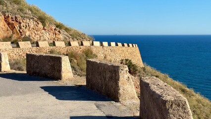 Stunning Coastal View Featuring Rock Walls and Crystal Clear Ocean Water, Truly Breathtaking