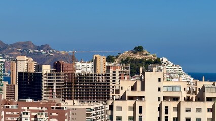 Fototapeta premium Experience the stunning coastal view showcasing urban architecture and majestic mountains