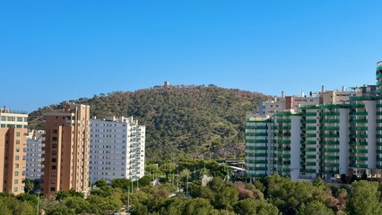 A Stunning Panoramic View of a Vibrant Urban Landscape with Rolling Hills and Modern Structures