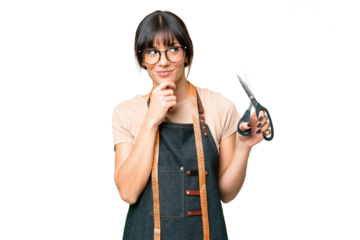 Young caucasian seamstress over isolated on chroma key background looking to the side and smiling