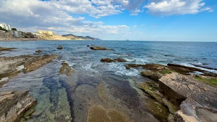 Enjoy the stunning coastal view with a rugged shoreline and a vibrant blue ocean backdrop