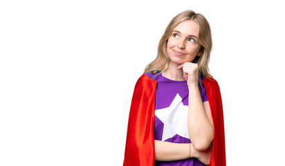 Young English woman over isolated background in superhero costume and thinking