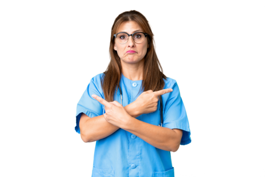Middle age nurse woman over isolated background pointing to the laterals having doubts