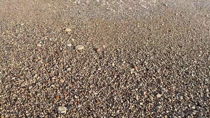 A picturesque, scenic seaside shoreline featuring a beautiful pebbled beach along the coast