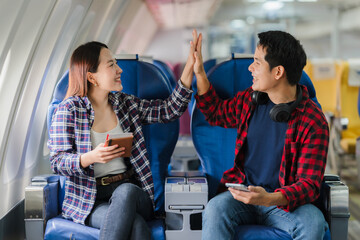 Couple Celebrating Success on Airplane