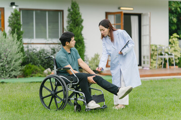 Doctor Examining Patient in Wheelchair Outdoors
