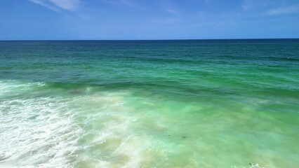 Experience a Serene Coastal View featuring Turquoise Waters and Gentle, Relaxing Waves