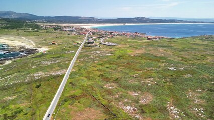 Stunning Aerial View of a Beautiful Coastal Landscape Featuring a Road and the Ocean Beyond