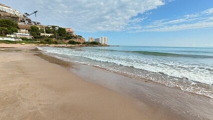 Experience the Serene Beachfront, where Gentle Waves meet Blue Skies, creating an idyllic escape