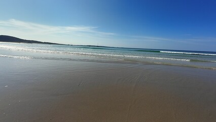 A Beautiful Serene Beach View Featuring Gentle Waves and an Expansive Clear Sky Above