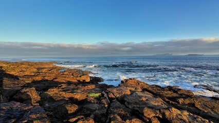 A Beautifully Serene Coastal Landscape Featuring a Rocky Shoreline and Calm Waters for Relaxation