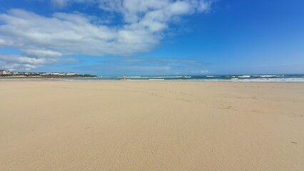 A Serene Beach Landscape Under Clear, Bright Blue Skies Perfect for Relaxation and Adventure