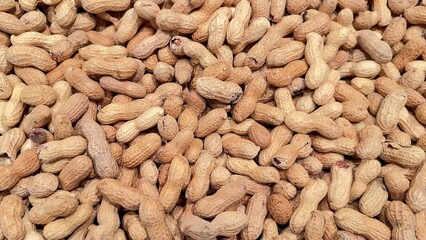 A display of raw peanuts presented elegantly on a flat surface for viewing and enjoyment