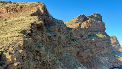 Stunning Coastal Rock Formation Under a Bright Clear Blue Sky on a Beautiful Day
