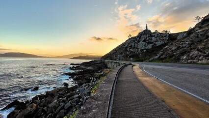 A Scenic Coastal Road at Sunset A Display of Natures Serene and Stunning Beauty