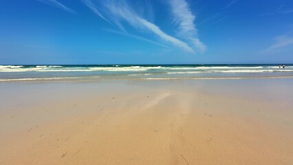 A Beautiful Serene Beach Landscape Featuring a Vibrant Azure Sky and Gentle Waves Lapping