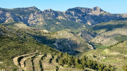 The mountain landscape has rolling hills and clear blue skies that invite exploration