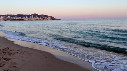 Experience breathtaking beach sunsets with reflections and gentle waves crashing ashore